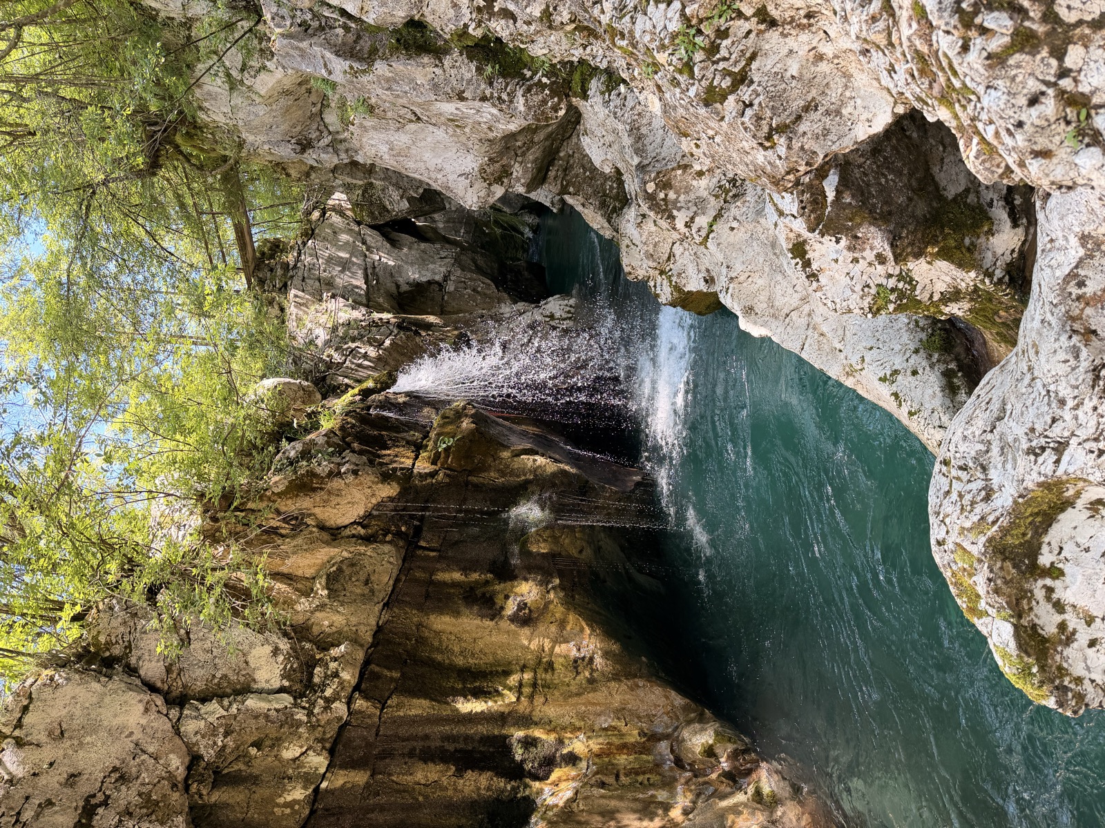 A magical waterfall under a bridge.